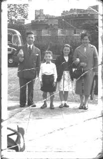 the small one wearing a kilt. With parents and sister on a day trip to London. Circa 1959